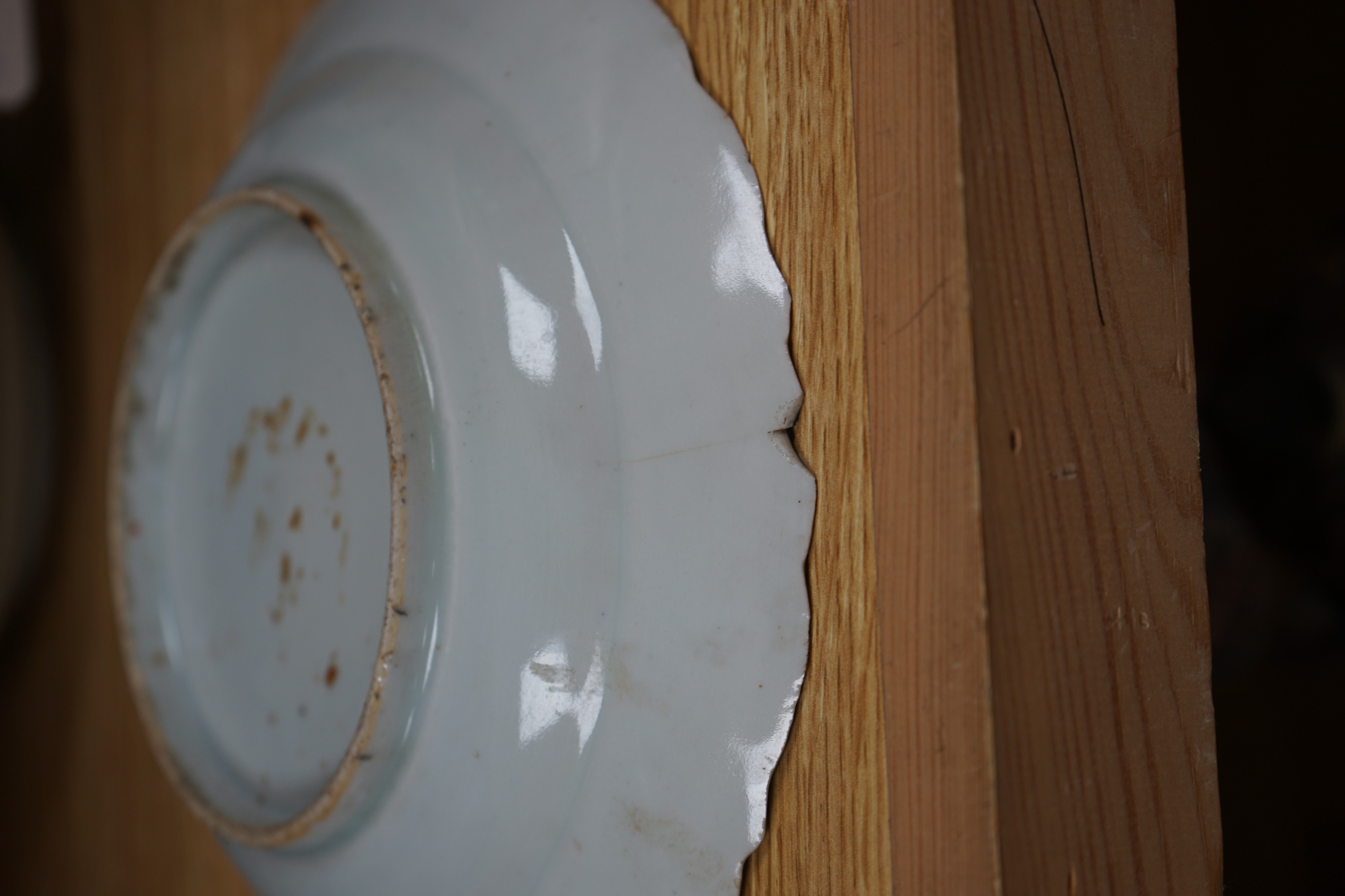 A set of eight Chinese plates with orange 'lotus' centres and blue floral borders, Qing dynasty, Dia 20cm